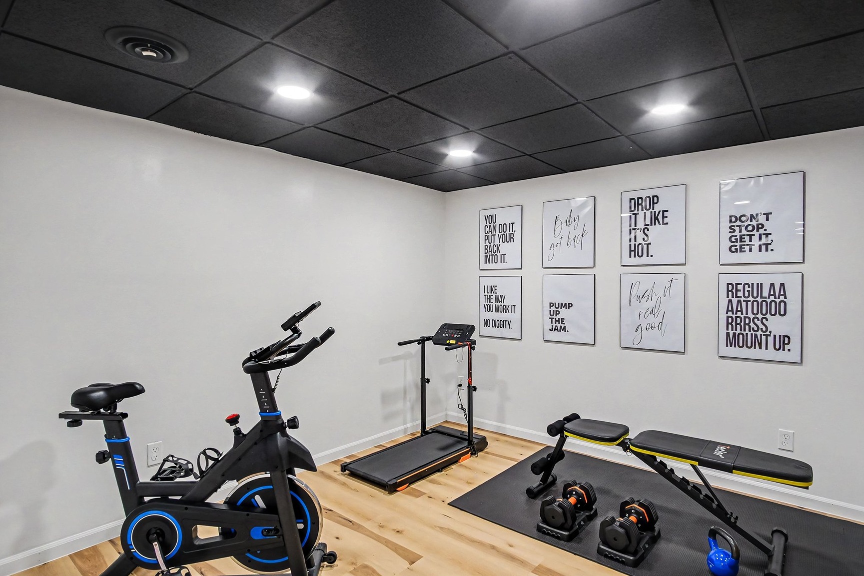 Exercise room with bike, treadmill, bench, and weights