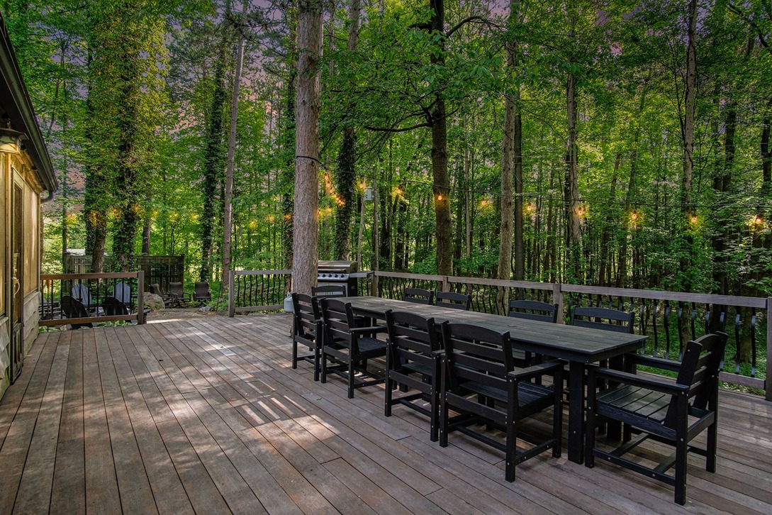 Evening deck dining area with string lights in the trees